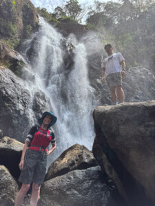 People near a waterfall in nature