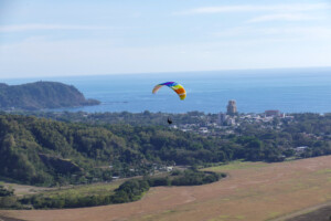 Paraglider pilot flying in Jaco, Costa Rica