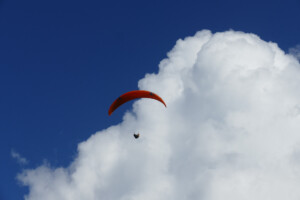Paraglider pilot in climbing up to cloudbase in Jaco, Costa Rica.
