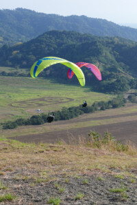 Two Paragliders, just off launch, working together to try to find lift.