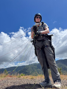 Looking up at a paraglider pilot ready to launch.