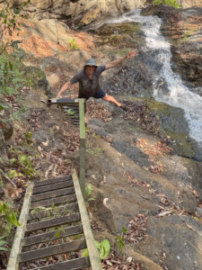 Andrew, hamming it up on the ladder back up from the waterfalls below. Quite the view