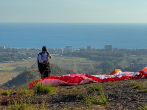 Paragliding pilot, just finishing his pre-flight check, overlooking Jaco