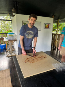 One of our students getting ready to spread the freshly made chocolate on the marble tempering plate.