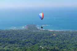 Up high, but it's a long way to the beach! Discover Paragliding Tour one, high in the sky over the Dominical launch. Beach in the background.