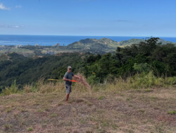 Cleaning up launch for the season. An annual task. Brad, raking launch clean of the tall grass that grows on launch during the rainy season.