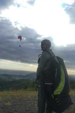 Paraglider pilot at launch in Jaco.
