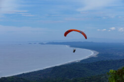 Dominical. Such a pretty place to fly! Paraglider flying above Dominical - Las Escaleras.