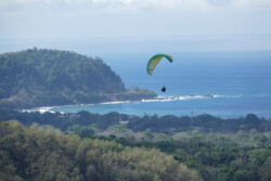 Paraglider with the coast in the distance.