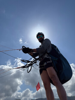 Fun camera angles. Paraglider pilot ready for launch. One of Brads favorite camera angles, with the sun behind the pilot.