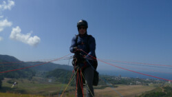 Paraglider pilot ready to launch. Jaco in the background.