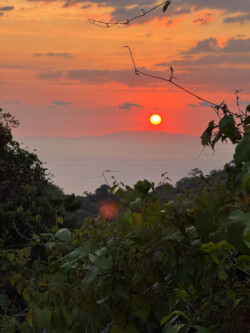 A fiery red sunset over the Nicoya Penninsula as viewed from the hills above Jaco. Costa Rica.